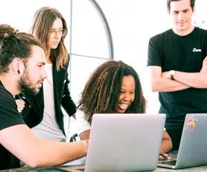 Professionals gathered around a laptop