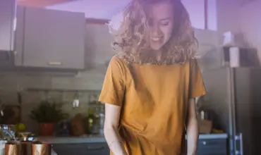 Woman happy in the kicthen doing housework during lockdown