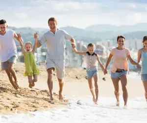 Large family holding hands on the beach